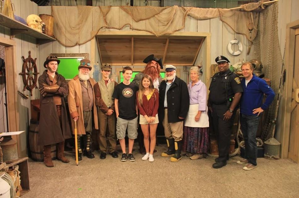 The cast of “Quahog Corner” pose on the set of “Captain Salty’s House” used in the new app.