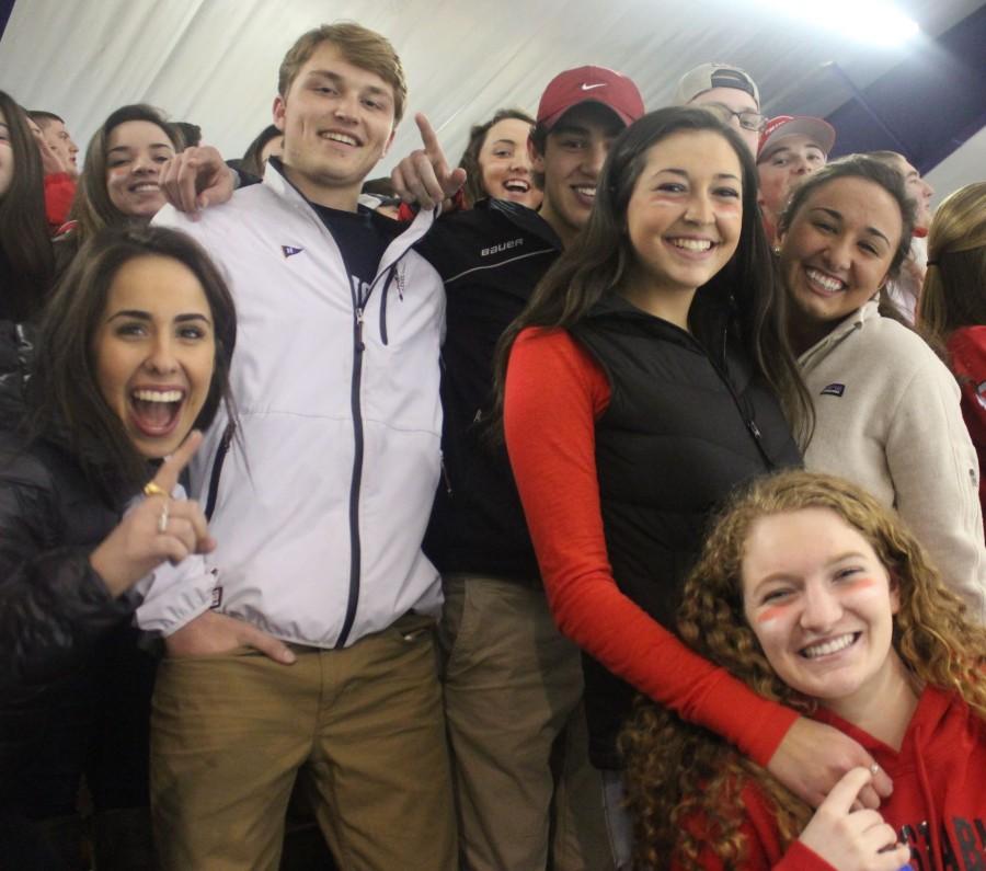 Barnstable fans smile for the camera at a hockey game where the Barnstable Raiders took on the Falmouth Clippers.