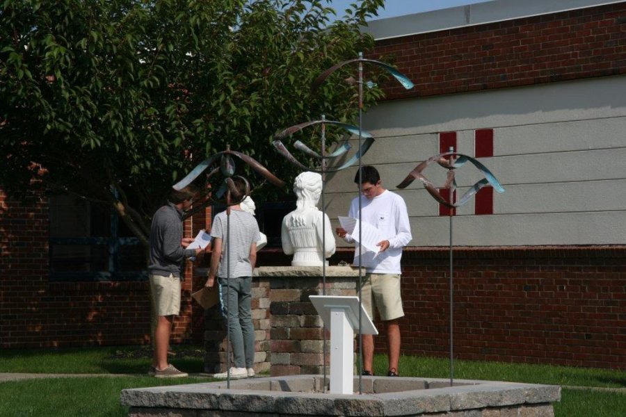 Students observe the sculpture in the Astro Park 