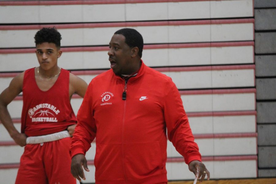 New Basketball Coach, Alik Taylor, instructs his players on the court.