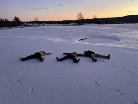 Olivia Donellan and family laying in the snow  when they were stuck in Sweden. 