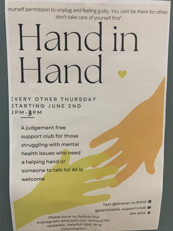 A poster in the hallway for the Hand and Hand club.