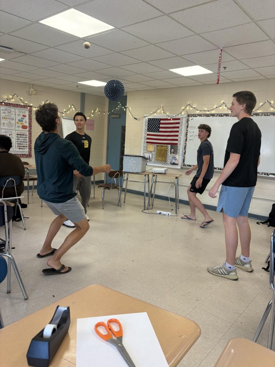 Students playing hacky sack during a free moment in class.
